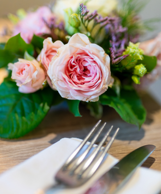 Roses and tables set up for a reception at L’Orangerie