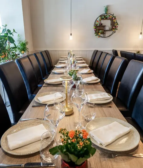 Long table set up for a group meal at L’Orangerie, a restaurant in Montargis